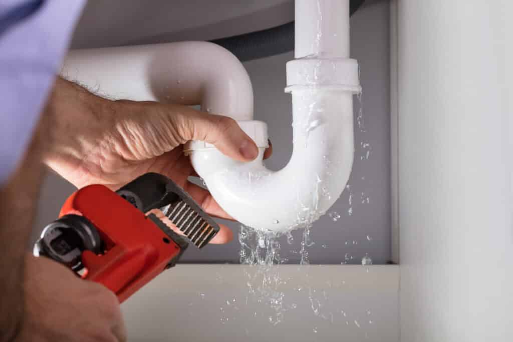 Plumber repairing kitchen sink